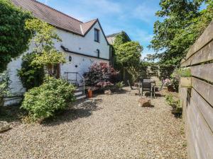 a garden in front of a white house at Stable Cottage, Narberth in Narberth