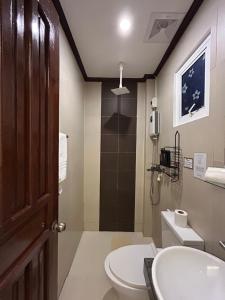 a bathroom with a toilet and a sink at Morocco Hotel El Nido in El Nido +59 photos