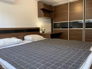 a bedroom with a large bed and wooden cabinets at Apartments Kivi in Novigrad Istria