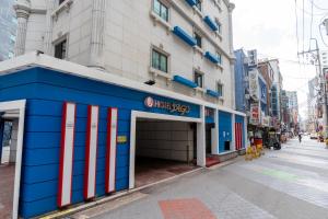 a blue building on the side of a street at Yeongdeungpo Hotel Jago in Seoul