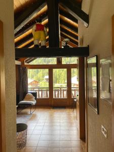 a view of a living room with a wooden ceiling at L'Attique du Vieux-Champex in Orsières