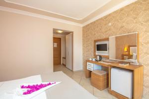 a hotel room with a bed and a desk at Nicholas Park Hotel in Oludeniz +16 photos