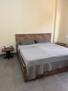 a large bed in a bedroom with a table at Étoile Batroun in Batroûn