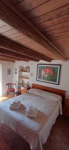 a bedroom with a large bed with two towels on it at Nespello Tourist Accommodation in Costa di Serina