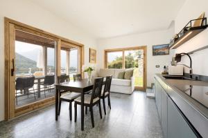 a kitchen and dining room with a table and chairs at Perla di Mergozzo 1 in Mergozzo