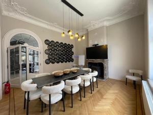 a dining room with a table and chairs and a fireplace at Villa Damseaux in Spa