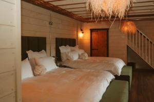 two beds in a room with a staircase at The Forest Loft in Drumsurn