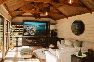 a living room with a fireplace and a tv at The Forest Loft in Drumsurn