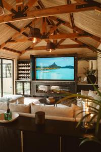 a living room with a large flat screen tv at The Forest Loft in Drumsurn +44 photos