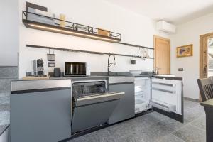 a kitchen with a sink and a stove at Perla di Mergozzo 1 in Mergozzo +12 photos