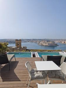 a patio with a table and chairs and a pool at Ursulino Valletta in Valletta +9 photos