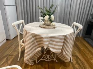 a table with a vase of flowers on it at Newport Cottage sleeps 5 in Newport