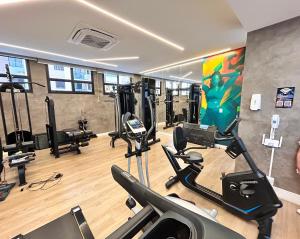 a gym with several treadmills and cardio machines at Lunar Lua Nova 06 in Aracaju