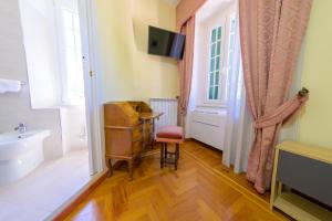 a bathroom with a sink and a toilet and a window at Villa dei Papi Subiaco in Subiaco