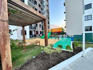 a playground with benches and a slide in a building at Lunar Lua Nova 06 in Aracaju