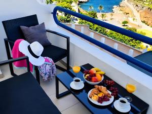 a table with a bowl of fruit on a balcony at Dream Ocean Sunset in Playa Paraiso