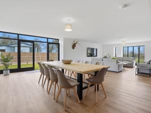a dining room with a wooden table and chairs at Partridge Barn - Uk52217 in Corton