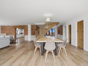 a dining room and living room with a table and chairs at Partridge Barn - Uk52217 in Corton +30 photos