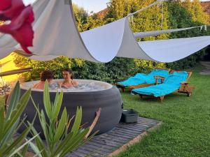 a woman in a hot tub in a yard at Borgo dei Duchi in Rivarolo Mantovano