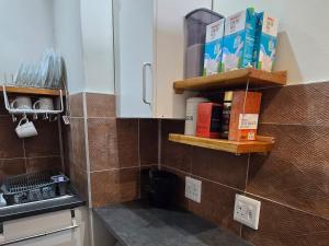 a kitchen with wooden shelves on the wall at Eternal @ Yzerfontein in Yzerfontein +47 photos