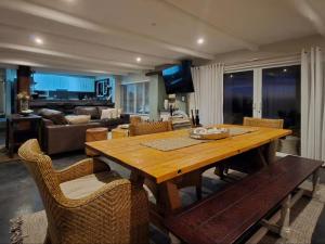 a living room with a wooden table and chairs at Eternal @ Yzerfontein in Yzerfontein