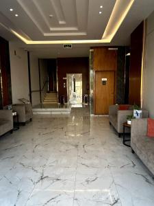 a lobby with a large marble floor and a lobby at شقق كالم للشقق المخدومة 1 in Riyadh