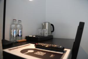 a table with two remote controls and bottles of water at Hôtel Restaurant Lamy in Troisvierges