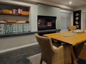 a dining room with a wooden table and chairs at Eternal @ Yzerfontein in Yzerfontein