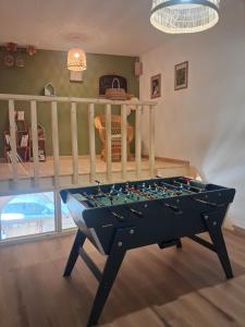 a pool table in the middle of a room at La grange famille in Tournans +6 photos