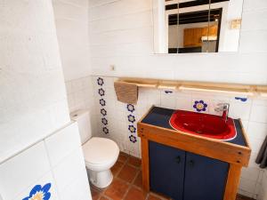 a bathroom with a red sink and a toilet at Havane13 in Hastière-par-delà +16 photos
