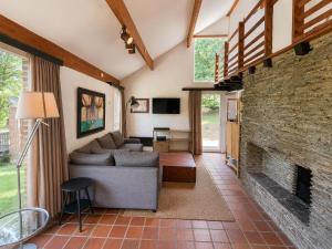 a living room with a couch and a brick fireplace at Havane13 in Hastière-par-delà