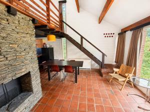 a living room with a table and a staircase at Havane13 in Hastière-par-delà