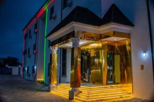 a building with columns in front of it at night at De Grand Vale Hotel and Suite in Abuja