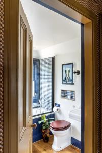 a bathroom with a toilet and a tub and a sink at The Loch Lomond Arms Hotel in Luss +30 photos