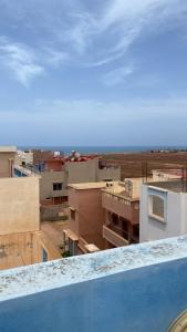 a view of a city from the balcony of a building at Mirleft Hostel in Mirleft