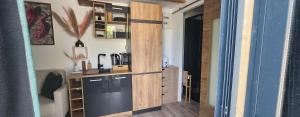 a kitchen with a wooden partition in a room at Le Chalet romantique avec jacuzzi privatif in Lirac