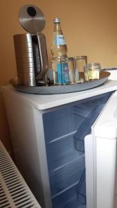a white table with a bottle and glasses on it at Vorsicht Hôtel in Deyelsdorf +3 photos