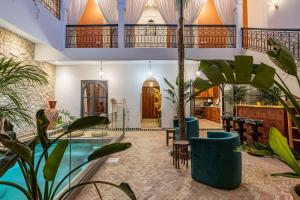 a room with plants and a swimming pool at Traditional Villa Dar Izza - 4 suite with breakfast in Douar Soukkane
