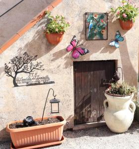 a building with a door and flowers and butterflies on it at Il Casaletto del Terminillo in Rieti
