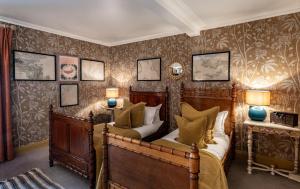 a bedroom with two beds and two lamps at The Loch Lomond Arms Hotel in Luss