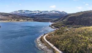 an aerial view of a lake with snow covered mountains at Bamsen hytte in Evenskjer