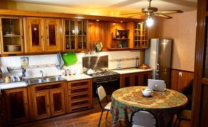 a kitchen with a table with a laptop on it at Backpackers Georgia in Tbilisi City