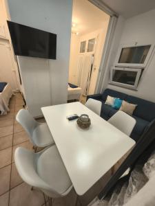a living room with a white table and a couch at Manarola Sunset House in Manarola
