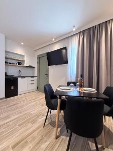 a kitchen and dining room with a table and chairs at Monte Vista Lemnos Apartments in Myrina