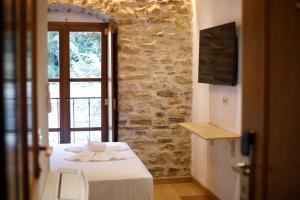 a bedroom with a bed and a window in a room at Hotel Kashah in Gjirokastër +111 photos