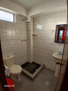 a bathroom with a toilet and a sink at Qamana Soto S in Uyuni +17 photos