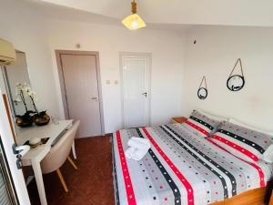 a bedroom with a bed with a desk and a bed sidx sidx sidx at Dream House in Tsarevo