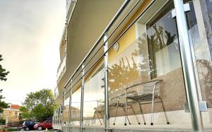 a chair sitting in the window of a building at Къща за гости ,,Лозница ГТ'' in Varna City
