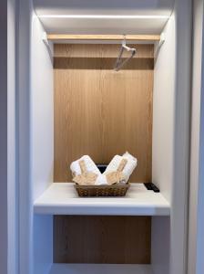 a bathroom with a basket of towels on a shelf at Monte Vista Lemnos Apartments in Myrina +41 photos