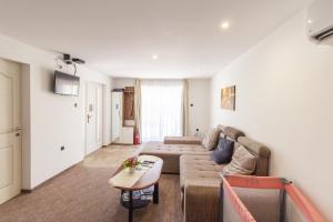 a living room with a couch and a table at Déli Terasz A Apartman Free parking, self-check-in anytime in Győr